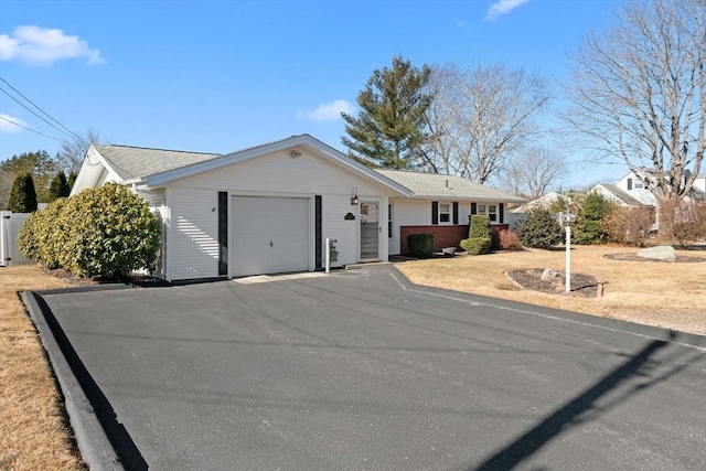 single story home featuring a garage and driveway