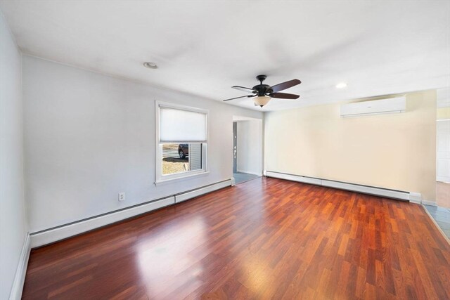 unfurnished room with a baseboard radiator, baseboard heating, an AC wall unit, ceiling fan, and wood finished floors