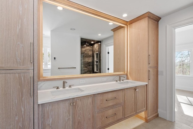 bathroom with a shower, recessed lighting, a sink, and double vanity