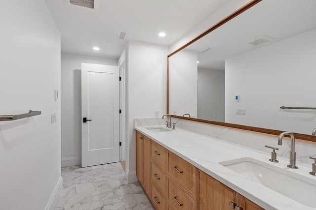 bathroom featuring double vanity, marble finish floor, visible vents, and a sink