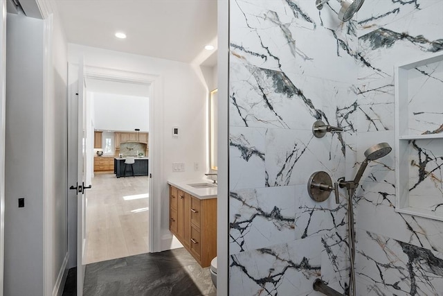 bathroom with a shower, toilet, ensuite bathroom, vanity, and recessed lighting