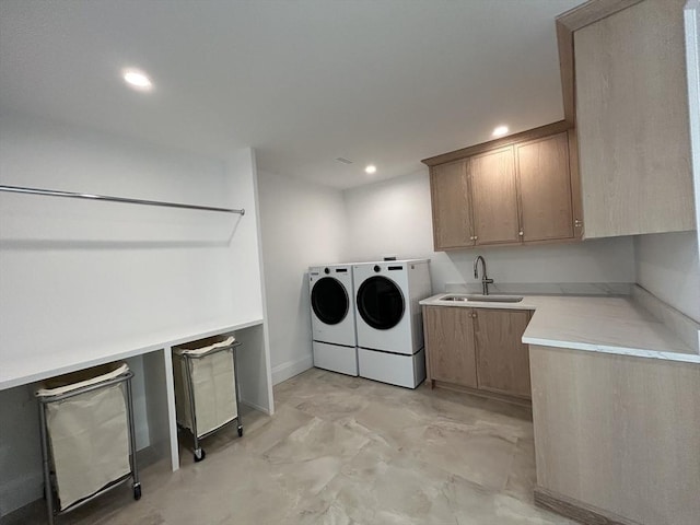 laundry area featuring washer and dryer, cabinet space, a sink, and recessed lighting