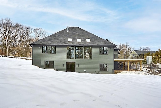 view of snow covered rear of property