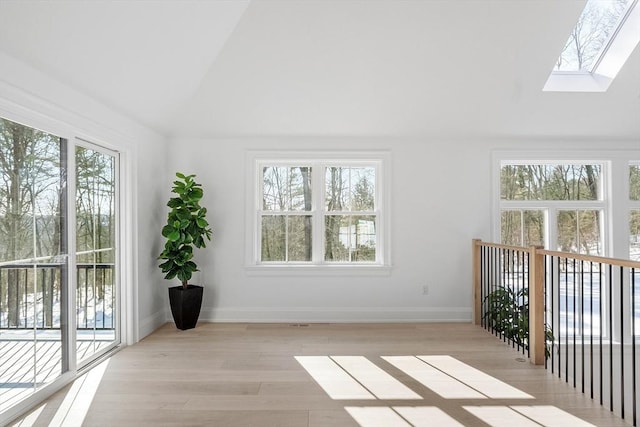 unfurnished sunroom with lofted ceiling with skylight and a wealth of natural light