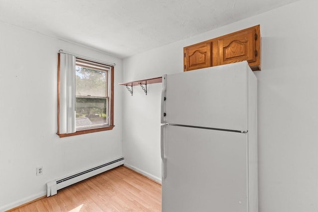 3 Meadow Way, Norton, MA 02766 - kitchen with freestanding refrigerator, baseboard heating, light wood finished floors, brown cabinets, and baseboards