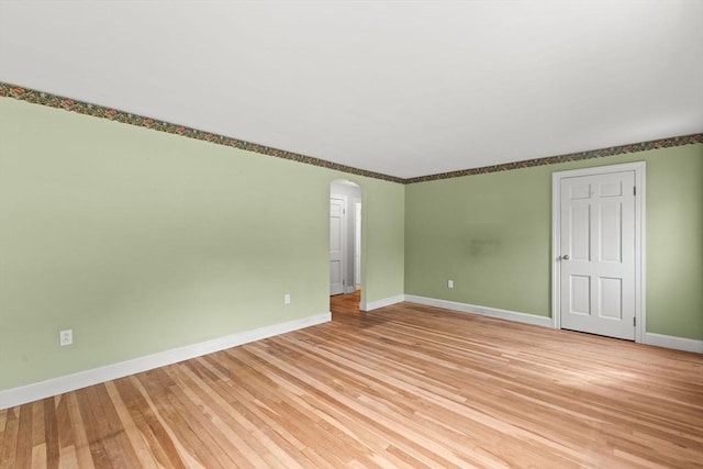 3 Meadow Way, Norton, MA 02766 - unfurnished room featuring arched walkways, baseboards, and light wood-type flooring