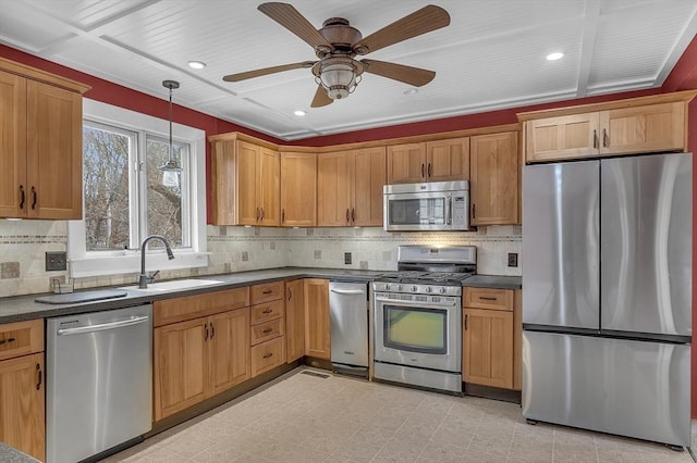 kitchen featuring tasteful backsplash, stainless steel appliances, ceiling fan, sink, and decorative light fixtures