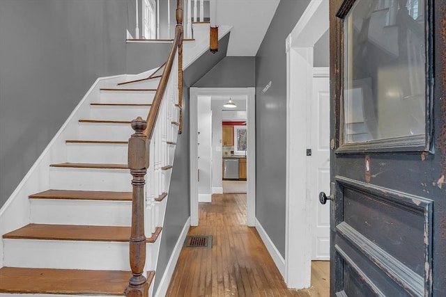 stairway with hardwood / wood-style floors