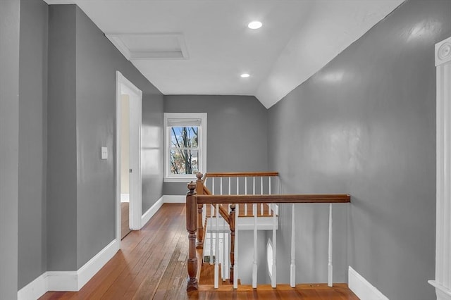 hall with hardwood / wood-style flooring and vaulted ceiling