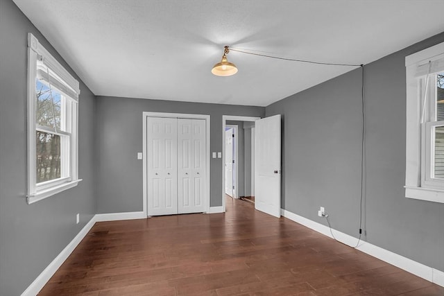 unfurnished bedroom featuring dark wood-type flooring