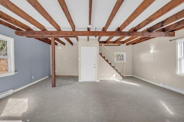 unfurnished living room with carpet, beam ceiling, and a baseboard heating unit