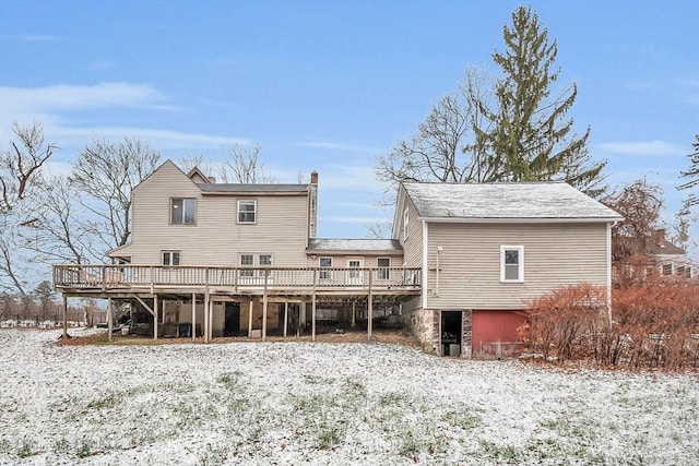 snow covered house with a deck