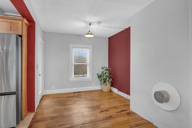 unfurnished dining area with light wood-type flooring