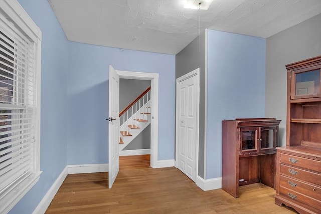 hallway with light hardwood / wood-style flooring