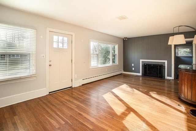 entryway with a fireplace, dark hardwood / wood-style flooring, and baseboard heating