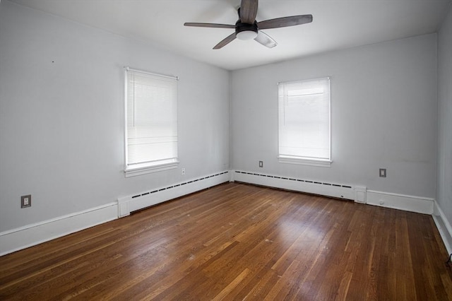 spare room with baseboard heating, ceiling fan, and dark hardwood / wood-style flooring