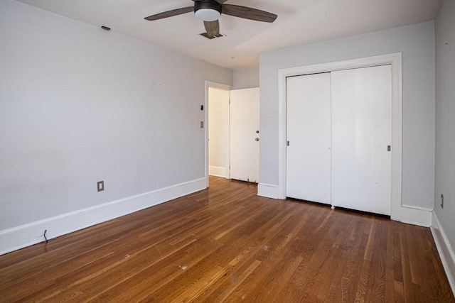 unfurnished bedroom featuring a closet, ceiling fan, and dark wood-type flooring