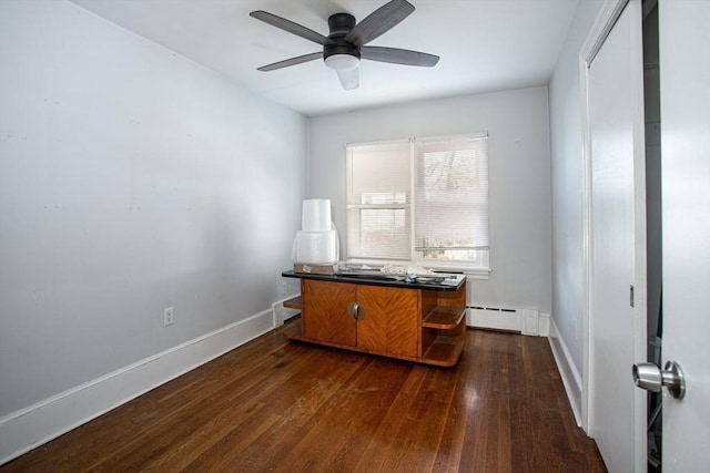 home office featuring dark hardwood / wood-style flooring, a baseboard radiator, and ceiling fan