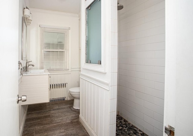 bathroom with vanity, radiator heating unit, crown molding, toilet, and wood-type flooring