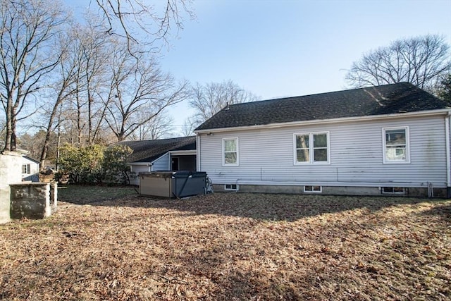 view of side of home featuring a hot tub