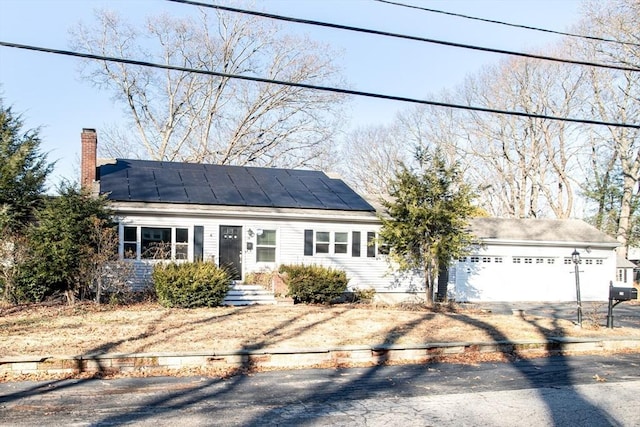 view of front of house with a garage and solar panels