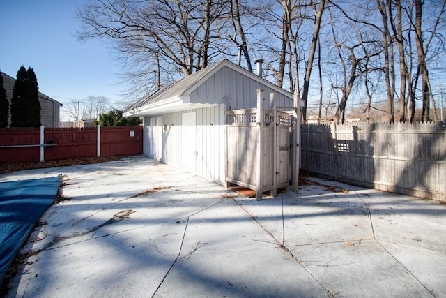 view of side of property with an outbuilding and a patio