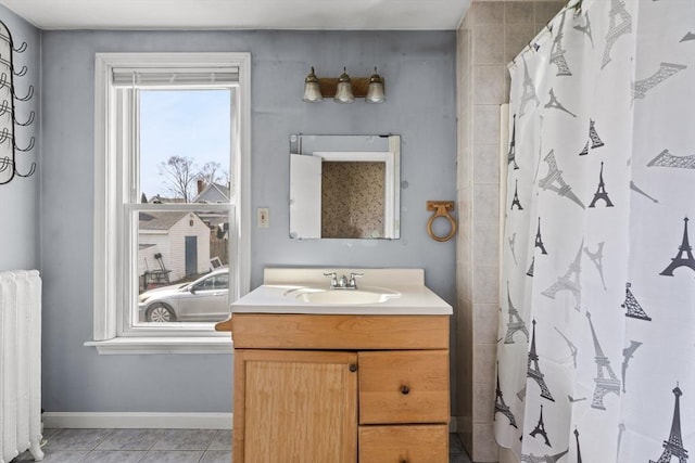 bathroom with radiator, a shower with shower curtain, vanity, tile patterned flooring, and baseboards