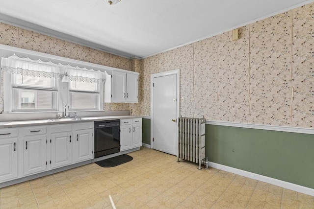 kitchen with black dishwasher, light floors, radiator, light countertops, and a sink