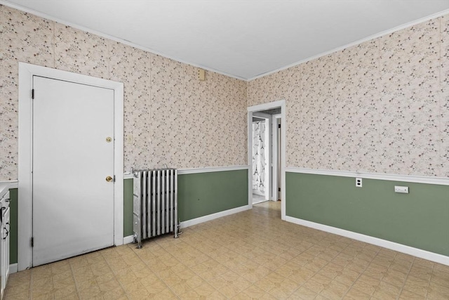 unfurnished room featuring crown molding, baseboards, tile patterned floors, and radiator