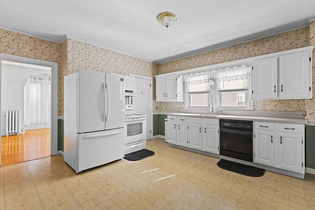 kitchen featuring white appliances, wallpapered walls, radiator, light floors, and under cabinet range hood