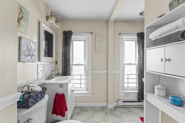 bathroom with marble finish floor, baseboards, baseboard heating, and vanity