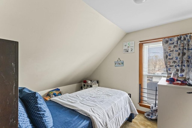 bedroom featuring vaulted ceiling, carpet floors, and baseboards