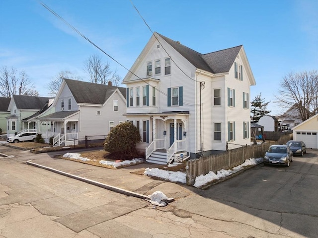 view of front of home featuring a residential view and fence