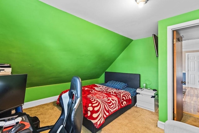 bedroom featuring vaulted ceiling and baseboards