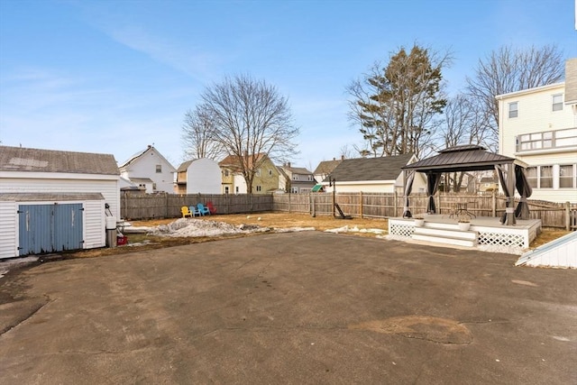 view of yard featuring a gazebo, a patio area, and a fenced backyard