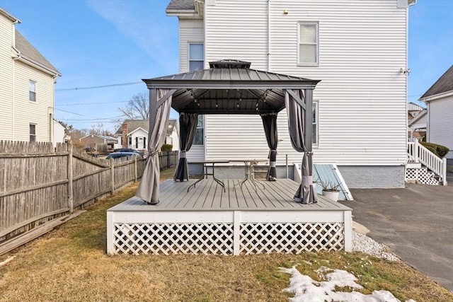 wooden terrace with fence and a gazebo