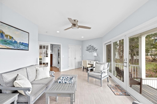 living room with ceiling fan, light wood-style flooring, and recessed lighting