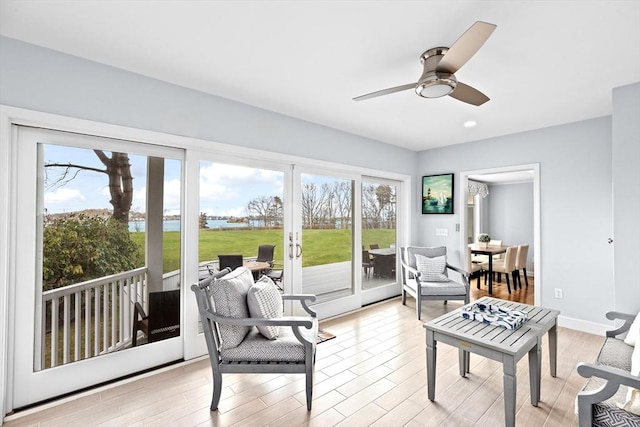 sunroom / solarium featuring a water view