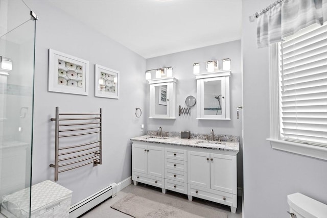 full bathroom featuring double vanity, a sink, a baseboard radiator, and a stall shower