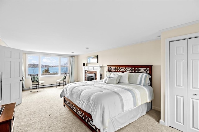 bedroom with carpet, a water view, crown molding, baseboards, and a baseboard radiator