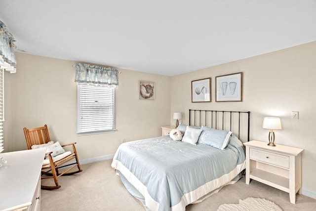 bedroom featuring baseboards and light colored carpet