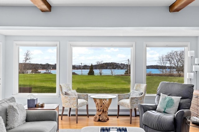 sunroom / solarium featuring baseboard heating, beam ceiling, and a water view