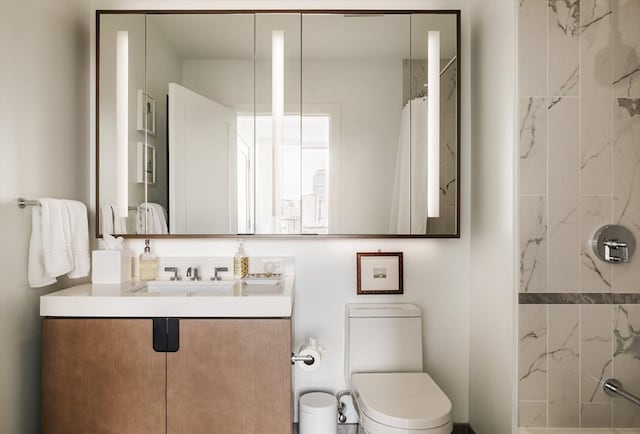 bathroom featuring vanity, toilet, and walk in shower