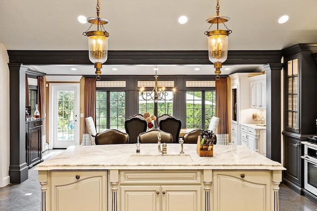 18 Connors Way, Leominster, MA 01453 - kitchen with cream cabinets, plenty of natural light, pendant lighting, ornamental molding, and recessed lighting