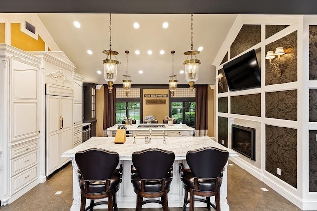 18 Connors Way, Leominster, MA 01453 - kitchen with a large island with sink, vaulted ceiling, a kitchen breakfast bar, recessed lighting, and light stone counters