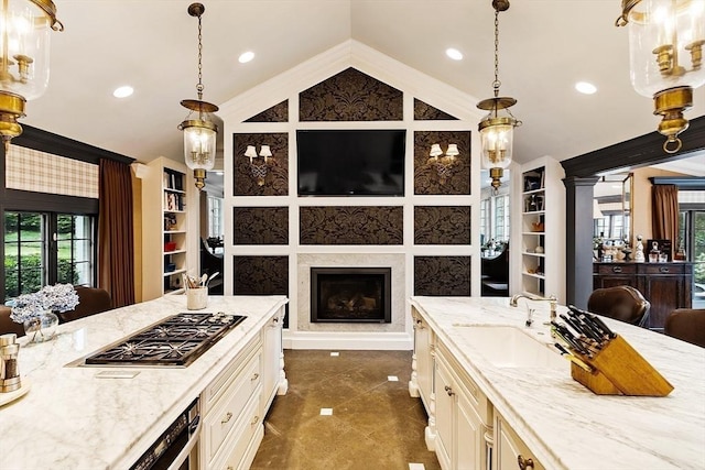18 Connors Way, Leominster, MA 01453 - kitchen featuring a sink, stainless steel gas stovetop, vaulted ceiling, light stone countertops, and ornamental molding