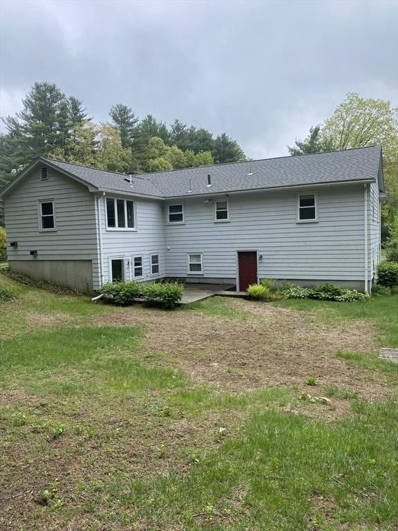 rear view of property with a patio area and a yard