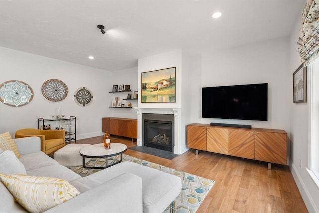 34 Sumner St Unit 34, Norfolk, MA 02056 - living room with a fireplace with flush hearth, light wood finished floors, and recessed lighting