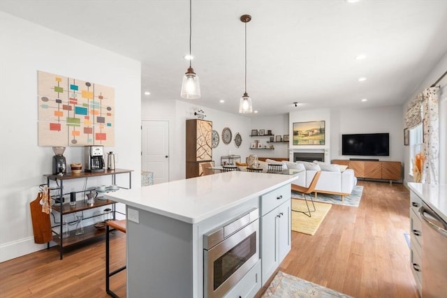 34 Sumner St Unit 34, Norfolk, MA 02056 - kitchen featuring stainless steel appliances, light wood-style flooring, recessed lighting, a kitchen island, and light countertops