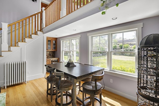 dining room with light hardwood / wood-style floors and radiator heating unit